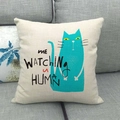 Detail of linen cushion showing turquoise cartoon cat print and ME WATCHING HUMAN text - Turquoise Cat Style