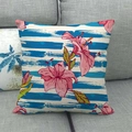 Linen cushion cover featuring dark blue stripes and vibrant pink lilies on a gray sofa - Navy Stripe Hibiscus Style (1)