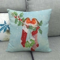 Sky blue linen Christmas cushion cover featuring robins and winter motifs on a grey sofa - 45x45cm / Robin and Sock Blue Background (13)