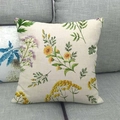 Linen blend square pillowcase with plum blossom and bird prints on a grey fabric sofa - Yellow and Purple Small Flowers (4)
