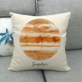 Close-up of Jupiter planet print on a square linen cushion cover on a grey fabric sofa - Jupiter