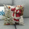 Linen Christmas cushion cover featuring Santa Claus and decorated tree on a grey sofa - Santa Claus with Gifts under Tree Style (18)