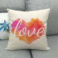 Linen square pillowcase with watercolor heart and white Love text on a grey sofa - Love Heart Style (10)