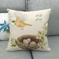 Linen decorative pillow cover with birds, nest, and Hello Spring text on a gray sofa - Hello Spring Bird Nest (15)