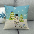 Close-up of linen Christmas pillow cover with snowman and trees on grey sofa - Snowman With Double Christmas Trees Style
