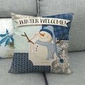 Detailed texture of Christmas snowman cushion cover featuring Winter Welcome design on sofa - Winter Welcome Snowman Patchwork Style