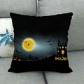 Detalle de funda de cojín de Halloween con luna amarilla y castillo en un sofá gris - Estilo HALLOWEE Luna Llena Negra (4)
