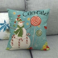 Linen Christmas pillow cover with a smiling snowman and Celebrate text on grey sofa - Celebrate Snowman Candy Style