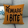 Halloween orange bat cushion cover with Beware I Bite text on a grey sofa - 18x18 Inch / Orange Beware I Bite Bat Style (6)
