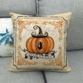 Linen Halloween cushion cover with pumpkin and wizard hat print on a gray sofa - Pumpkin Wizard Hat (1)