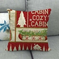 Fodera per cuscino natalizio in lino con motivi a baita e fiocchi su divano grigio - 45x45 cm / Stile 14 (Baita Accogliente)