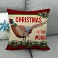 Detail eines Weihnachtskissens mit rot-schwarzem Karomuster und Fasanen-Motiv auf Sofa - Fasanen-Muster (3)