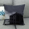 Detail of linen pillowcase featuring a gothic haunted house design on a gray sofa - Lakeside Ghost Wooden House (6)