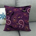 Close-up of a purple Halloween pillow cover featuring a witch hat and bat on a grey sofa - Purple Witch Hat Bat Broom (11)