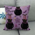 Detail of purple Halloween pillowcase featuring Hocus Pocus text and witch cauldron on sofa - Purple Witch Cauldron and Legs (12)