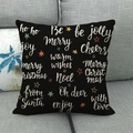 Detail of black Christmas cushion cover with golden Merry Christmas script on sofa - Black Gold Christmas Text (2)