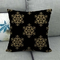 Detail of black linen pillowcase featuring a golden snowflake pattern on grey sofa - Black Gold Snowflake (4)