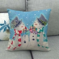 Detail of Christmas snowman linen pillowcase on a sofa featuring hand-painted winter scene - Two Snowmen Holding Gifts Winter Style (15)