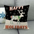 Close-up of linen Christmas pillow cover with white deer design on gray fabric sofa - Happy Holidays Nordic Textured Deer(9)