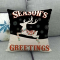 Detail of linen Christmas reindeer pillow cover featuring Season's Greetings text on sofa - Season's Greetings Ornate Jumping Deer(12)