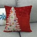 Close-up of red linen Christmas pillowcase with white tree on a gray sofa - Red Hand-painted Christmas Tree (7)