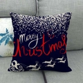 Close-up of linen Christmas pillow case with Merry Christmas text on a grey sofa - Navy Blue Sleigh Reindeer Silhouette Style (5)