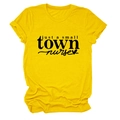 Detail of a bright yellow cotton T-shirt featuring a black 'just a small town nurse' graphic - Yellow (Black Font)