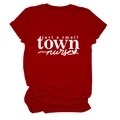 Flat lay of a red cotton nurse t-shirt with just a small town nurse white print - Red (White Font)