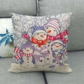 Linen Christmas pillowcase featuring four cute cartoon snowmen on a grey sofa - Four Snowmen Family
