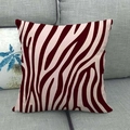 Detail of red zebra pattern linen cushion cover on a grey sofa fabric texture - Red Zebra Print Style (7)