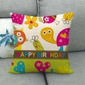 Detail of linen cushion cover with cartoon owls and Happy Birthday text on sofa - Owl Snail Patchwork Birthday Style (9)