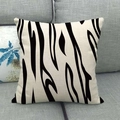 Square linen throw pillow with black abstract zebra pattern on a minimalist gray sofa - Black Beige Irregular Texture (1)