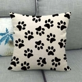 Linen square throw pillow cover featuring minimalist black paw prints on grey sofa - Black White Paw Prints (3)