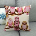 Detail of cartoon owl linen pillow cover showing fabric texture on a grey sofa - Diverse Owl Group (10)
