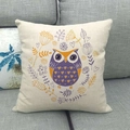 Close-up of linen cushion cover featuring decorative owl and flower art on a sofa - Purple Yellow Owl (12)