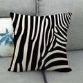 Linen throw pillow cover with a classic black and white zebra pattern on a gray sofa - Modern Zebra Print Style (16)