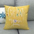 Macro detail of yellow linen cushion with white Celebrate You text on a grey sofa - Yellow Celebration Celebrate You Style (15)