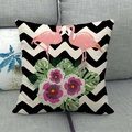 Detail of linen texture pillow cover with flamingo and tropical floral print on grey sofa - B&W Herringbone Double Flamingo