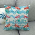 Tropical flamingo linen cushion cover with blue wave patterns on a grey fabric sofa - Blue Wave Palm Flamingo
