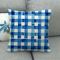Close-up of blue and white watercolor checkered linen throw pillow on a grey sofa - Blue White Watercolor Plaid (7)