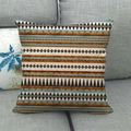 Linen cushion cover featuring brown geometric triangles and turquoise accents - Brown and Green Ethnic Geometric Triangles