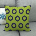 Close-up of green linen pillow cover with blue geometric ikat patterns on grey sofa - Grass Green Deep Blue Ikat Circle (9)