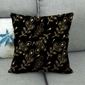 Detail of black linen pillow case with golden leaf pattern on a grey fabric sofa - Golden Plant Leaves