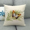 Close-up of a butterfly and grass pattern printed on a beige linen cushion cover - Orange Butterfly Grassland Style (5)