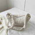 Chic beige quilted cloud shoulder bag with stylish wave pattern and knotted strap detail - White