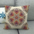 Linen style square pillowcase with mandala heart pattern on a dark grey sofa - Rose Red Heart Mandala (13)