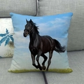 Running black horse linen pillowcase displayed on a grey fabric sofa with a blue sky background - Black Horse Sky Field(26)