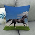 Linen cushion cover featuring a blue running horse print on a grey fabric sofa - Black Horse Green Field Blue(32)