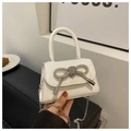 Detail of white mini crossbody bag with a rhinestone butterfly bow and silver chain strap - White