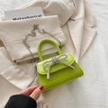 Mini lime green crossbody bag with rhinestone bow and silver chain strap details - Green